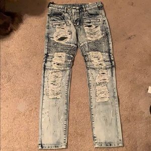 Pair of men’s distressed denim Moto jeans.